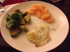 Parmesan garlic fried egg, brussel sprouts sauteed with a bacon and clementines. Perfect post-workout meal